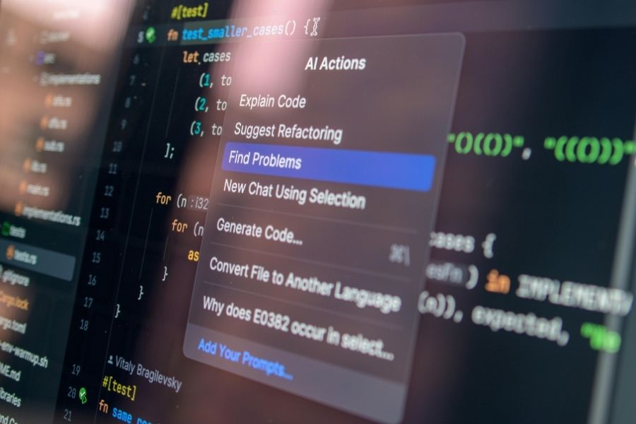 A computer screen displays lines of code with an open AI Actions context menu highlighting AI coding assistants features.