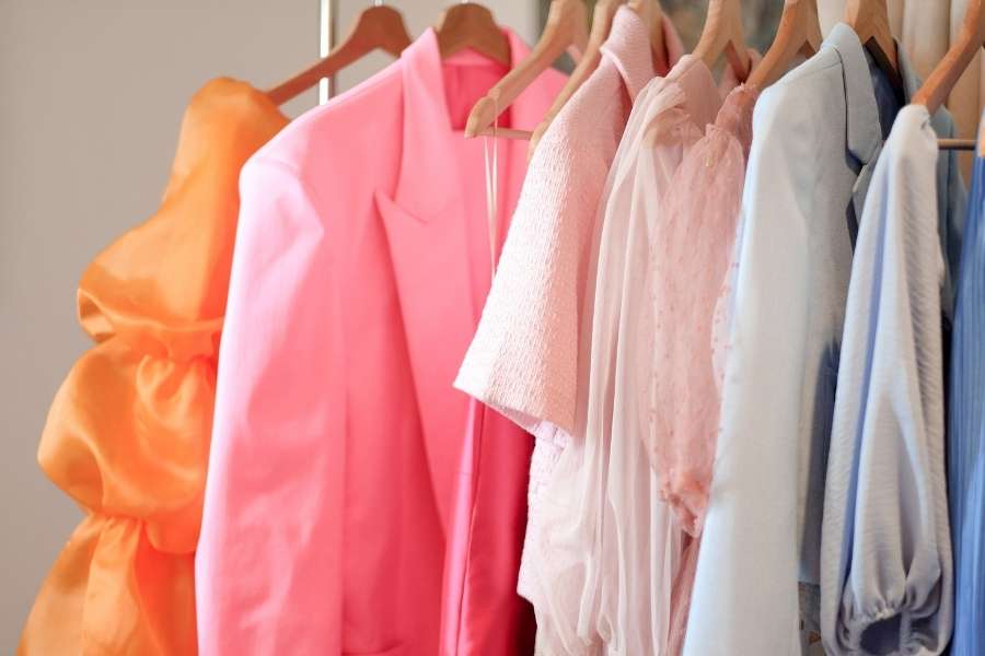 A rack of vibrant, multi-colored clothing options perfect for those who enjoy mixing patterns and textures.
